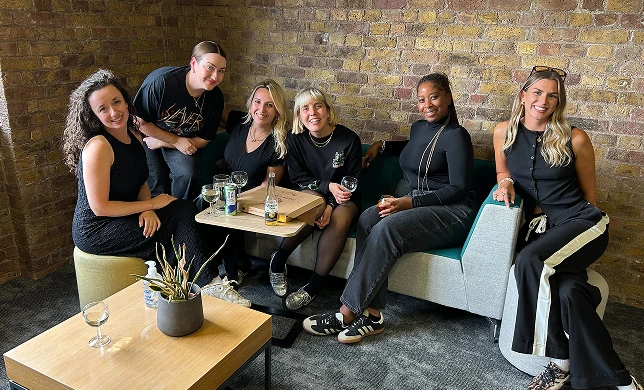 Vidsy teammates relaxing together on a sofa in the studio lounge