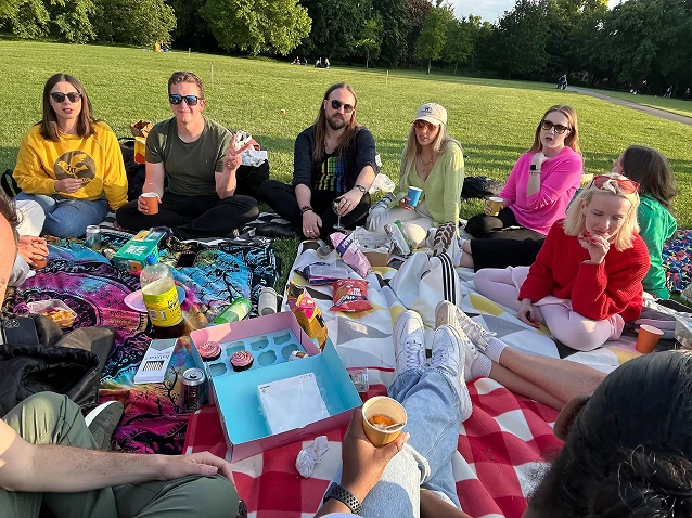 Vidsy team enjoying a summer picnic on blankets in the park