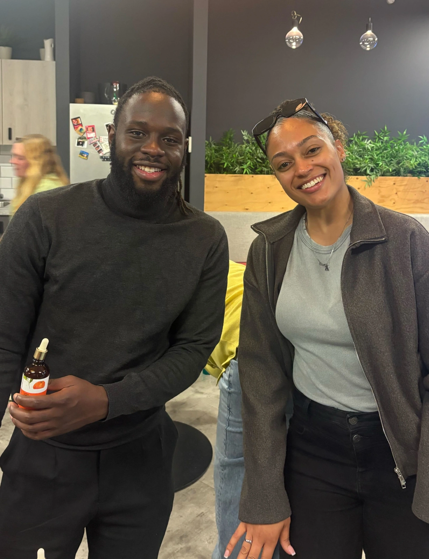 Two Vidsy colleagues smiling together at the December social party