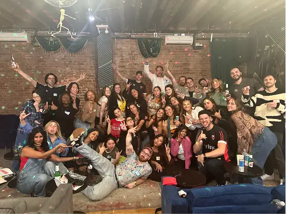 Large group of Vidsy staff gathered at an evening company party